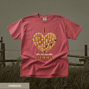 May include: Crimson t-shirt featuring a heart made of beer glasses. The words "I" and "BEER" are printed above and below the heart. The shirt is made of a soft material.
