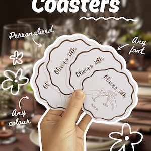 May include: A hand holds a stack of personalised coasters. The coasters are white with a scalloped edge and a brown border. Each coaster has the text "Olivia's 30th" and a drawing of two martini glasses. The image also includes the words "Coasters", "Personalised", "Any colour", and "Any font".
