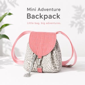 May include: A small backpack with a pink quilted flap and straps. The body of the bag has a white and gray spotted pattern. The text "Mini Adventure Backpack" and "Little bag, big adventures" is displayed on the image.