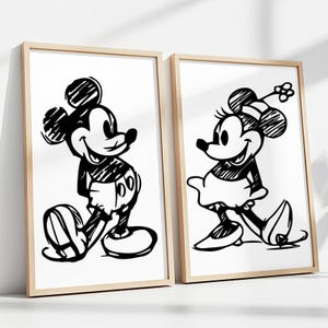 May include: Two framed black and white sketches of Mickey and Minnie Mouse. Mickey is wearing gloves and shorts. Minnie is wearing a dress and a bow. The frames are light brown.