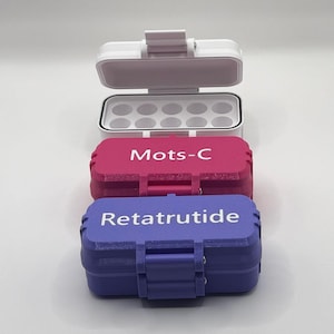 May include: Three rectangular storage cases with hinged lids. The top case is white and open, revealing ten circular compartments. The middle case is magenta with the white text Mots-C. The bottom case is purple with the white text Retatrutide.