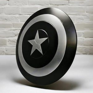 May include: A black and silver shield with a white star in the center. The shield has a circular design with a silver outer ring and a black center. The shield is leaning against a white brick wall.