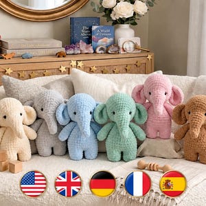 May include: A collection of six plush elephant toys made from soft, textured yarn. The elephants are arranged in a row and feature various colours including cream, grey, light blue, mint green, soft pink, and tan, each with black eyes.