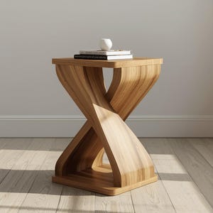 May include: A light brown wooden side table with a unique, twisted hourglass design. The table has a square top and base, with a central support that appears to be two interlocking curves. A stack of books and a small white vase sit on top.