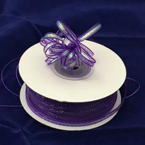 May include: A spool of purple iridescent ribbon with a bow tied on top. The ribbon is on a white spool with a white label.