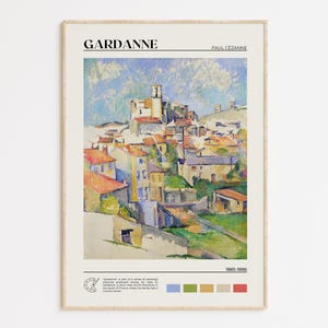 May include: A framed print of Paul Cézanne's painting, "Gardanne," featuring a colorful depiction of a village with red-roofed buildings under a blue sky. The print includes the artist's name and the painting's title.