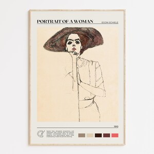 May include: A framed art print titled "Portrait of a Woman" by Egon Schiele. The artwork depicts a woman in a large hat, rendered in pencil and pastel tones. The print includes text and a color palette at the bottom.