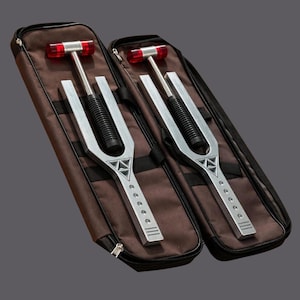 May include: A set of three ceramic mugs with a speckled, matte finish. The mugs are in shades of cream, light gray, and dark gray. Each mug has a simple, minimalist design and a rounded handle.