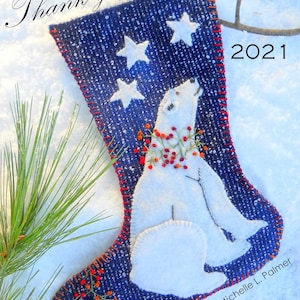 May include: A blue felt stocking with a white polar bear and red berries, decorated with white stars. The stocking is on a snowy background with pine branches. The text "Thank you, Friends!" and "2021" are visible on the stocking.