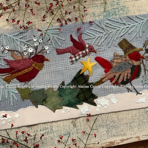 May include: A felt appliqué wall hanging with a winter theme. Three red birds are depicted with a star and a small evergreen tree. The background is a light blue plaid fabric.