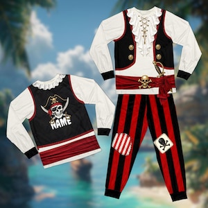 May include: A long-sleeved pirate-themed pyjama set featuring a white ruffled collar, black vest bodice with gold buttons, and red sash with a skull and crossbones emblem. The trousers have red and black vertical stripes with two decorative patches.