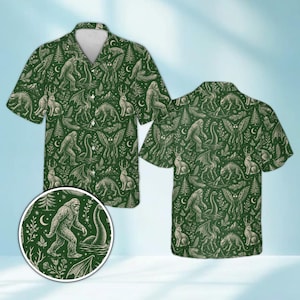 May include: A short-sleeve button-down shirt in dark green with an all-over cream-colored print featuring illustrations of Bigfoot, the Loch Ness Monster, Mothman, jackalopes, dragons, pine trees, crescent moons, and various botanical elements.