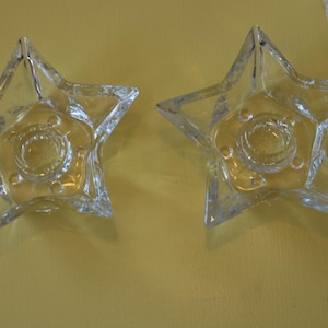 May include: A set of three ceramic mugs with a speckled, matte finish. The mugs are in shades of cream, light gray, and dark gray. Each mug has a simple, minimalist design and a rounded handle.