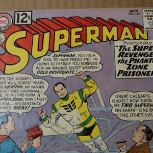 May include: A vintage Superman comic book cover featuring a yellow and green supervillain with the text "The Super-Revenge of the Phantom Zone Prisoner!" and "Great Caesar's Ghost! Now there will be two Supermen on Earth--one good, the other evil!"