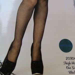 May include: Black thigh-high stockings with a fine fishnet pattern. The stockings are shown on a model wearing black heels. The product packaging includes the text "20304 Thigh High One Size Black".