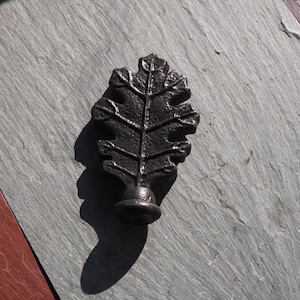 May include: A set of three ceramic mugs with a speckled, matte finish in cream, light grey, and dark grey. Each mug has a simple, modern design and a rounded handle.