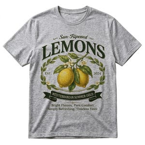 May include: A heather gray t-shirt featuring a vintage-style graphic of lemons. The design includes the text "Sun-Ripened LEMONS" above a wreath with two lemons and the text "MEDITERRANEAN SUMMER GOLD". Additional text reads "Bright Flavors, Pure Comfort, Simply Refreshing, Timeless Taste."