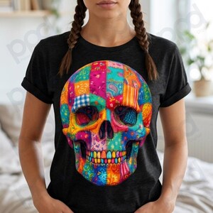 May include: Black t-shirt featuring a colorful skull design. The skull is composed of patchwork patterns in vibrant hues of pink, blue, orange, and yellow. The design is centered on the shirt.