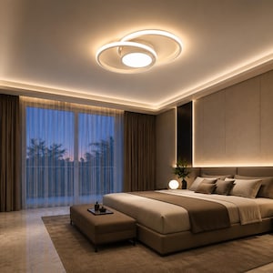 May include: A modern bedroom with a large bed, a bench, and a marble-topped dresser. The room features a large window with sheer curtains, a decorative ceiling light, and recessed lighting. The color scheme is neutral with brown and beige tones.