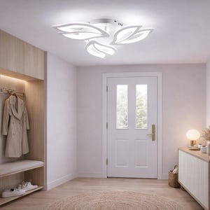 May include: A modern entryway with a white leaf-shaped ceiling light fixture. The room features a wooden cabinet, a round mirror, and a coat rack. A beige coat hangs on the rack. The floor is light-colored wood.