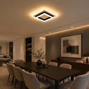 May include: A modern dining room with a dark wood table and eight beige chairs. A square, black and white ceiling light illuminates the space. A large abstract artwork hangs on the gray wall, with a wooden cabinet and a potted plant.