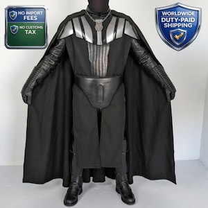 May include: A full-body costume featuring a black cape, chest armor, and a belt. The costume includes black boots, gloves, and a helmet. The chest armor is silver and black. The costume is designed to resemble a character from a science fiction film.