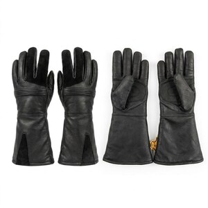 May include: Four black leather gloves with extended cuffs. Two gloves show the back with suede panels on the fingers and ribbed detailing at the wrist. Two gloves show the palm side with reinforced padding and a small tan leather tag on the cuff.