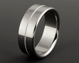 Simple white titanium wedding ring in a flat profile and one centered pinstripe