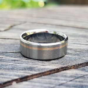 Titanium ring with one off center 18k solid rose gold inlay, mens or womens wedding band