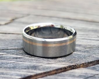 Titanium ring with one off center 18k solid rose gold inlay, mens or womens wedding band