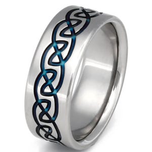 May include: A silver titanium ring featuring a black and blue Celtic knot design.