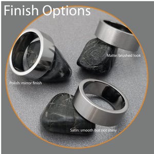 May include: Three silver-toned metal rings labeled Finish Options. One ring has a Polish: mirror finish, one has a Matte: brushed look, and one has a Satin: smooth but not shiny finish. Each ring is positioned on a dark, smooth, rounded stone.