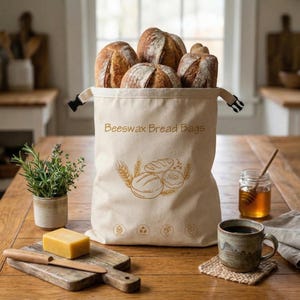 May include: A set of three ceramic mugs with a speckled, cream-colored glaze. Each mug features a different hand-painted floral design in shades of blue, green, and yellow. The mugs have a simple, modern shape.