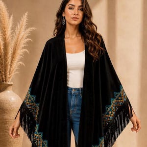 Luxury black velvet embroidered shawl with turquoise geometric embellishments and long fringe trim, styled as an elegant bohemian evening wrap for special occasions, formal dinners, weddings, and boutique fashion looks. Handmade statement shawl photographed in warm editorial studio lighting with premium velvet texture and detailed embroidery craftsmanship.