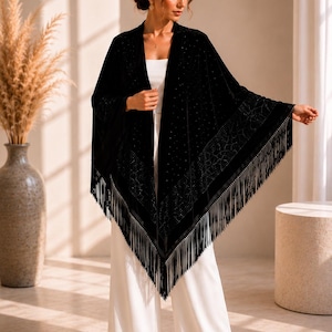 Woman modeling a luxury velvet shawl with shimmering crystal details, sophisticated evening wrap designed for wedding guests and special occasions.