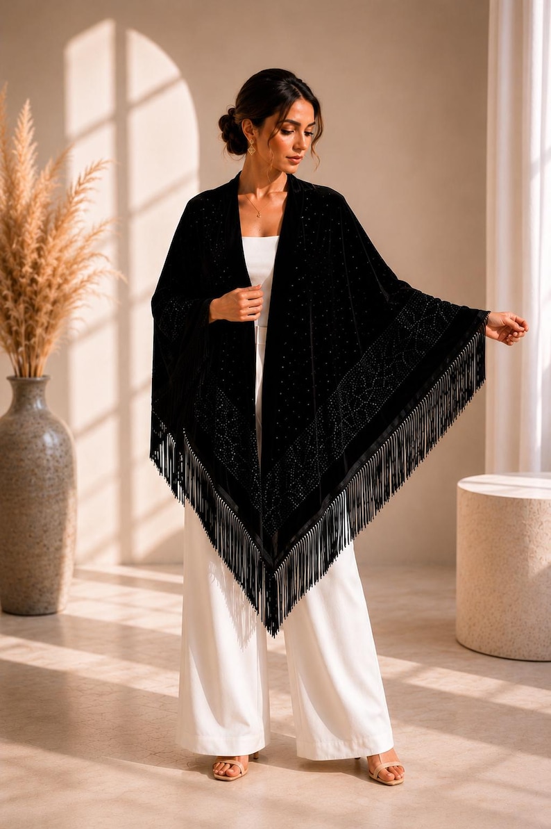 Woman modeling a luxury velvet shawl with shimmering crystal details, sophisticated evening wrap designed for wedding guests and special occasions.