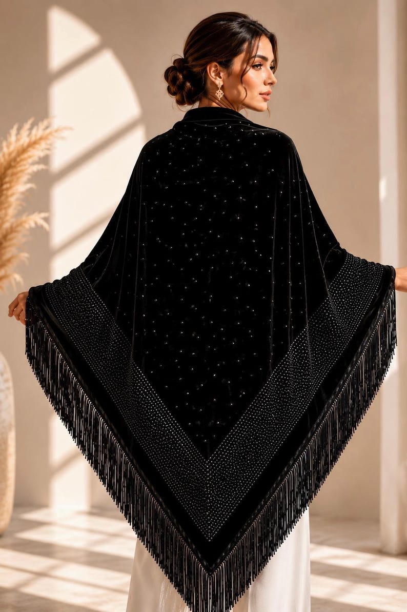 Back view of handmade black velvet evening shawl featuring shimmering crystal details and flowing fringe trim, elegant formal wrap for special occasions.
