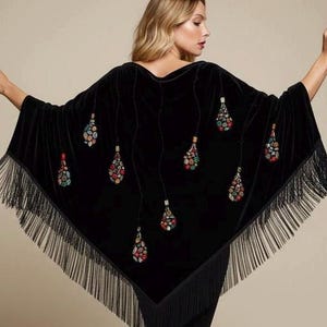 Black velvet shawl with colorful beaded teardrop designs. The shawl has a fringed hem and is a stylish accessory for any occasion. The teardrop designs are in shades of red, green, and blue.