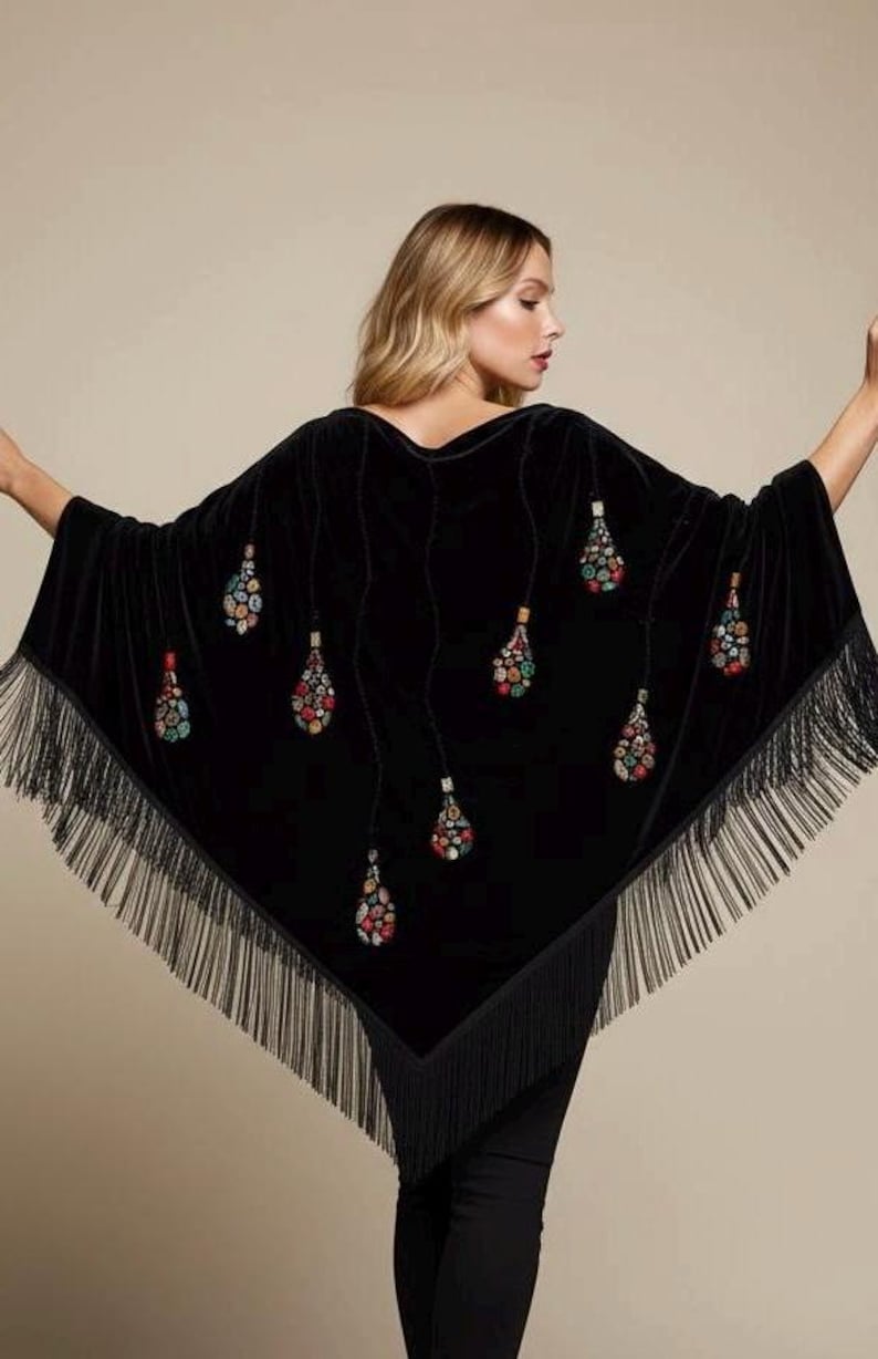 Black velvet shawl with colorful beaded teardrop designs. The shawl has a fringed hem and is a stylish accessory for any occasion. The teardrop designs are in shades of red, green, and blue.