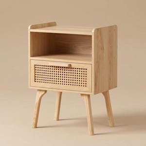 May include: A light wood bedside table featuring an open top shelf and a single drawer below. The drawer front is accented with a natural woven cane panel and a horizontal wooden handle. The unit is supported by four tapered wooden legs.