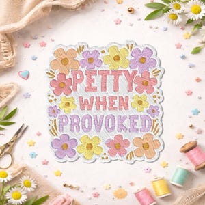 May include: Embroidered patch with the text "PETTY WHEN PROVOKED" surrounded by colorful flowers in shades of peach, pink, yellow, and purple. The patch is on a white background with sewing supplies and floral accents.