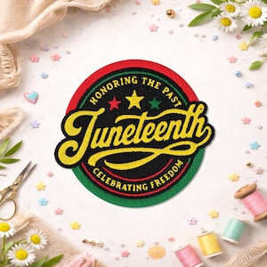 May include: A circular embroidered patch featuring a black background with a red and green border. The text reads Juneteenth in large yellow script, with Honoring the Past and Celebrating Freedom in yellow, plus three small stars.