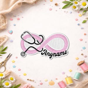 May include: An embroidered patch featuring a pink infinity symbol intertwined with a black stethoscope outline. The word Anyname is stitched in black cursive script at the bottom right of the infinity loop. The patch has a white border.