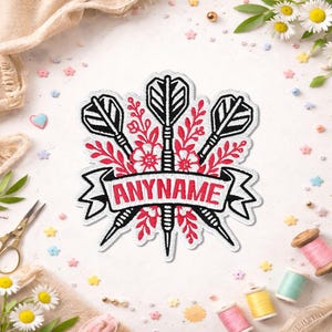May include: An embroidered patch featuring three black and white dart illustrations arranged vertically behind a central white banner with the red text ANYNAME, all surrounded by red floral and leaf embroidery details on a white fabric base.