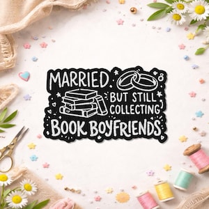 May include: A black patch with white text that reads "MARRIED BUT STILL COLLECTING BOOK BOYFRIENDS." The design includes illustrations of books and wedding rings. The patch is surrounded by decorative elements.