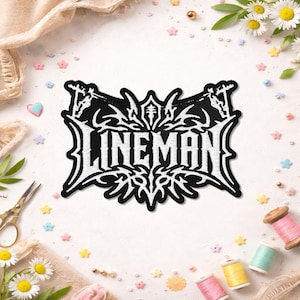 May include: A black and white embroidered patch featuring the word LINEMAN in a stylized, sharp-edged font. The design includes intricate, symmetrical decorative elements surrounding the text, with small utility pole icons at the top corners.