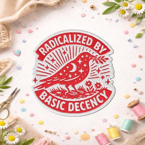 May include: Embroidered patch with a red bird design, holding a sprig, and the text "RADICALIZED BY BASIC DECENCY" in a circular layout. The bird has a crescent moon and star details. The patch is white with red embroidery.