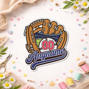 May include: Embroidered baseball patch with a mitt, a baseball with the number "00", and the word "Anyname". The patch is brown, blue, and white, with a stadium design inside the mitt. The patch is suitable for clothing.