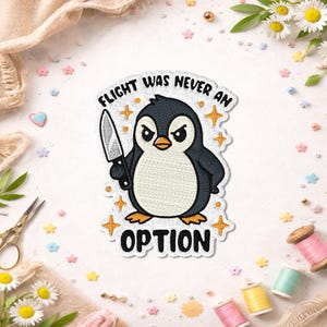 May include: An embroidered patch featuring a black and white penguin with an angry expression holding a silver knife. The text FLIGHT WAS NEVER AN OPTION is stitched in black above and below the penguin, surrounded by small orange star icons.