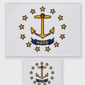 May include: White rectangular mat and coaster set featuring the Rhode Island state flag. The flag design includes a gold anchor, surrounded by thirteen gold stars, and a blue banner with the word "HOPE".